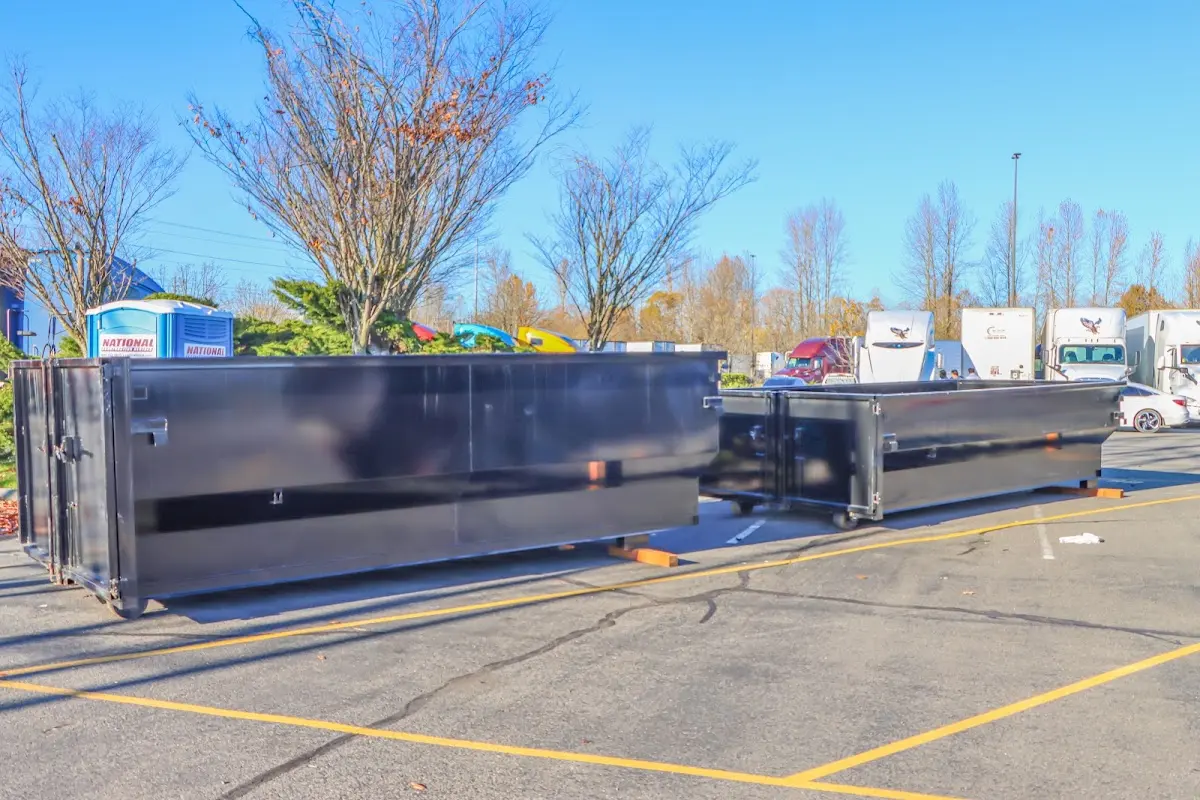 Professional dumpster rental service with roll-off container on residential driveway in Terrace Heights